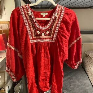 Red blouse with embroidered details